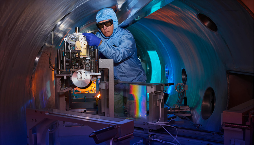 Rick Cross works on the Titan compressor system at the Jupiter Laser Facility. The gratings (rainbow reflection) allow the Titan laser to provide peak power while preserving the optical components of the system. (Photo: Garry McLeod/LLNL)