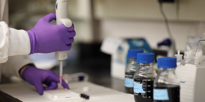 researcher using pipette in a science lab